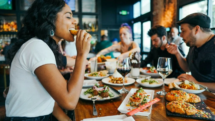 woman in white shirt eating